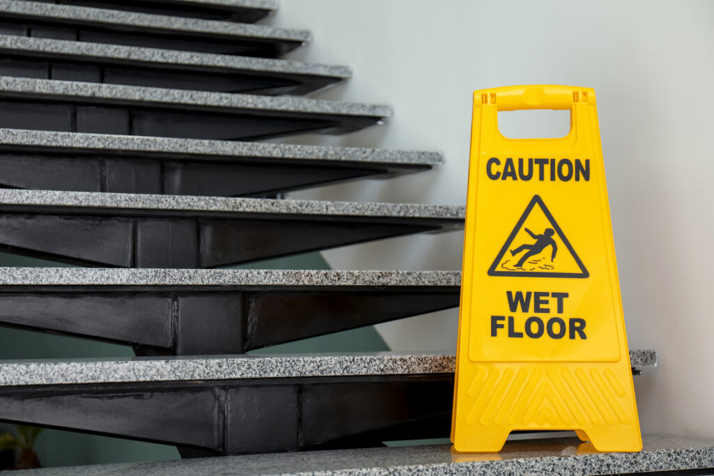 Safety sign warning of wet floor on stairway